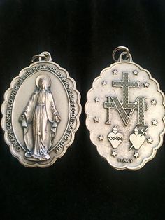 two medals with the image of jesus and mary on them, one in silver