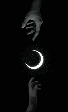 two hands reaching out towards each other in the night sky with a crescent above them