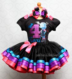 This set is perfect for your Vampirina Event! Set includes a 4 layer Black tutu trimmed in glitter and satin ribbon,and a custom Vampirina tee.HAIRBOW IS INCLUDED FOR A LIMITED TIME ONLY!Checkout our Other tutu sets in our shop under the tutu set section,if you dont see what you are looking for,contact us for a custom! WE DO NOT EXCEED PAST SIZE 6 This is our Deluxe version, use search term "vampirina" to see our standard versionIf you are unsure of sizing please scroll to the last photos for our size charts, or visit our size charts here--> https://pinktoesnhairbows.com/pages/size-chartAll sales are FINAL, Ship dates can be found directly on the listing, please view our policies in detail here---> https://pinktoesnhairbows.com/pages/policies-terms-conditions *****Due to Many Request,Bows 2nd Birthday Outfit, Babymoon Photos, Tulle Dresses, Black Tutu, Pink Toes, Birthday Idea, Halloween Cartoons