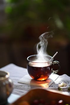 a cup of tea with steam rising from it