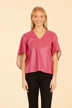 Our Faux Leather Cascade Sleeve Top is sure to be a striking addition to your autumn wardrobe. This versatile and stylish blouse features dramatic cascade sleeves that flow beautifully, adding movement and flair to your look. The sleek faux leather finish offers a modern edge, making it the perfect piece to complete your chic seasonal outfits. Faux leather Cascading sleeves V-neck Available in Black, Dark Pink, and Green Dry clean Style: 75634 Seasonal Outfits, Cape Designs, Fur Top, Midi Dress Formal, Autumn Wardrobe, Iconic Dresses, Leather Finish, Cape Sleeves, Stylish Blouse