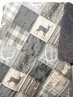 a blanket with deer and trees on it