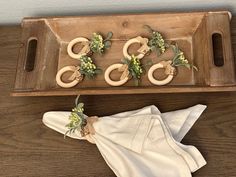 a tray with napkins and wooden rings on it