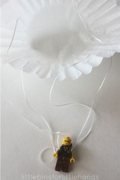 a lego figure is attached to a paper flower