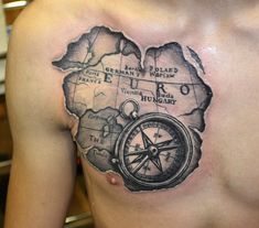 a man with a map tattoo on his chest holding a compass in the shape of a heart