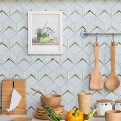 the kitchen counter is covered with wooden utensils