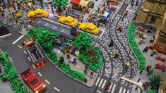 a lego model of a train station with cars and people