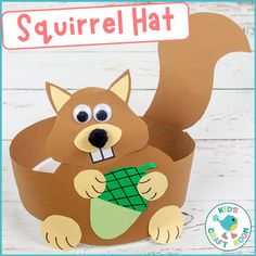 a paper squirrel that is holding an acorn in it's mouth with the words squirrel hat on it