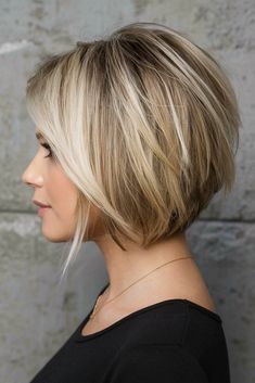 This angled bob haircut offers a dynamic look, with the front strands longer than the back, creating a modern edge. The vibrant blonde tones enhance the cut’s playful nature, making it ideal for women looking for a youthful transformation. Bob Angled Haircut, Short In Back Long In Front Bob, Back Of A Bob Haircut, Blonde Angled Bob Short, Below Chin Bob Haircuts, Short Bob With Blonde Highlights, Hair Styles Round Face Over 50, Angle Bob With Bangs, Short A Line Haircut With Layers