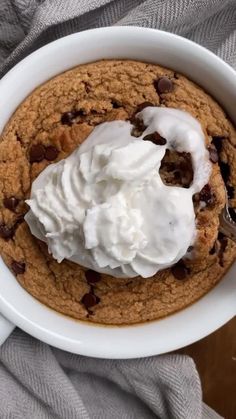 a bowl filled with chocolate chip cookies and whipped cream