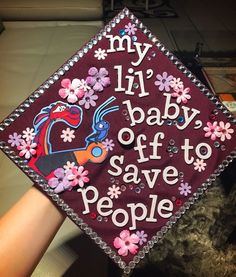 a graduation cap that says, my lil baby off to save people