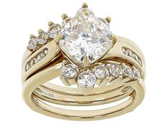 3.25ct cushion cut Lab Created Strontium Titanate solitaire with 1.28ctw round white zircon 18k yellow gold over sterling silver ring with guard. Measures approximately 0.63"L 0.25"W. Not sizable. Accent stones primarily zircon. Gold Diamond Ring With Vs Clarity Cushion Cut, Gold Cushion Cut Ring With Vs Clarity, Modern Diamond Rings, Mom Ring, Gemstone Colors, Diamond Rings, Sterling Silver Rings, Silver Rings, Fashion Jewelry