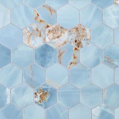 a blue and white mosaic tile with rust on it