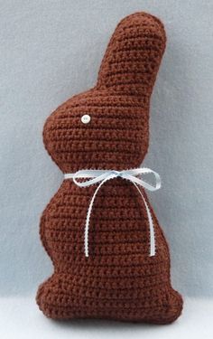 a brown crocheted stuffed animal sitting on top of a white table