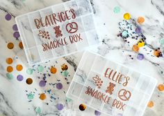 two clear boxes with glitters on them