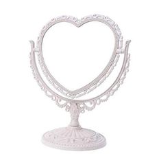 a white heart shaped cake stand on a white background