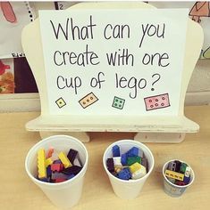 two buckets filled with lego blocks next to a sign that says, what can you create with one cup of lego?