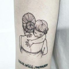 a small tattoo on the arm of a woman holding a child with words written below it