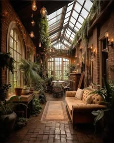 the inside of a house with lots of plants and lights hanging from it's ceiling