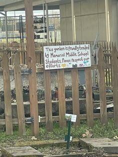 there is a sign that says this garden is fully fenced by memorial middle school students