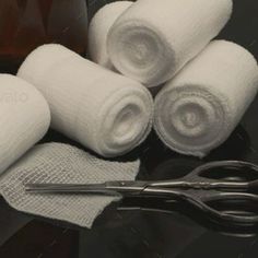 some white towels and scissors on a table