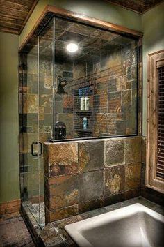 a bath room with a sink and a walk in shower next to a window on the wall