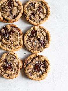 chocolate chip cookies are arranged on a white surface