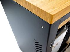 a wooden table top sitting on top of a computer