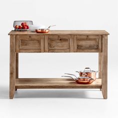 a wooden table with pots and pans on it