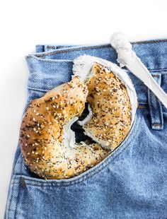 a bagel in the back pocket of a pair of jeans with a knife sticking out of it