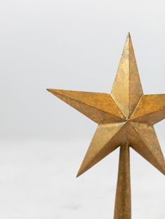 a gold star on top of a metal pole