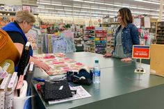 two women standing at a counter in a store