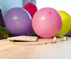 there are many balloons and a keyboard on the table