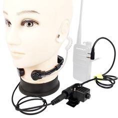 a head with a headset attached to it and a walkie talkie set up next to it