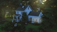 an aerial view of a white house surrounded by trees and bushes with the sun shining on it's roof