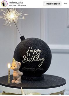 a birthday cake with a teddy bear holding a lit sparkler on top of it