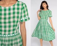 "Vintage 1960s dress in green and white plaid with a high fitted waist and a full skirt. Rear zipper. Please see measurements and condition below. Every garment we sell is authentic vintage and one-of-a-kind! You will receive the exact item photographed. Condition: Very good vintage. Has some small spots that may come out with treatment. Best fits women's: small Tag: none Material: Feels like Cotton/poly with a metal zipper MEASUREMENTS Taken from seam to seam while the garment is lying flat. Do Buffalo Plaid Dress, Vintage Dresses 1960s, 1960s Dress, 1960's Dress, Tartan Dress, Red Gingham, 1960s Fashion, White Buffalo