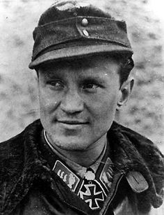 an old black and white photo of a man in uniform