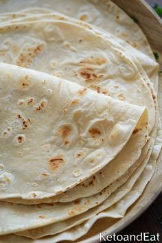 several tortillas stacked on top of each other in a bowl