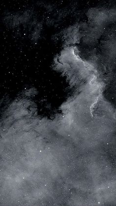 black and white photograph of clouds in the sky with stars on it's side