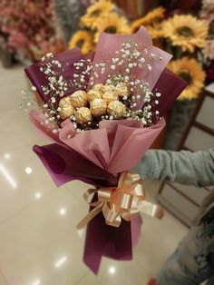 a bouquet of flowers with chocolates in it