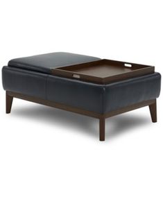 a black leather ottoman with wooden legs and a tray on the top that is open