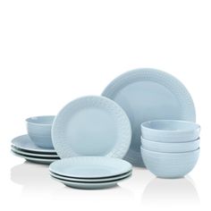 a set of blue dishes and plates on a white background