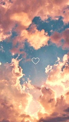 the sky is filled with clouds and a white heart