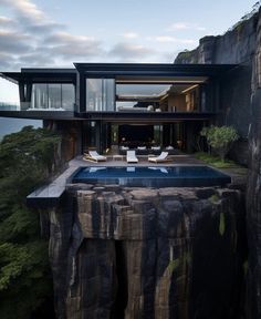 the house is on top of a cliff overlooking the ocean and mountains with a swimming pool