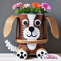 a brown and white dog planter with flowers in it