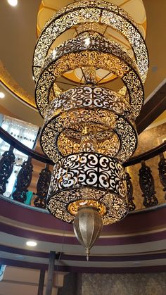 an elaborate chandelier hanging from the ceiling in a room with many lights on it