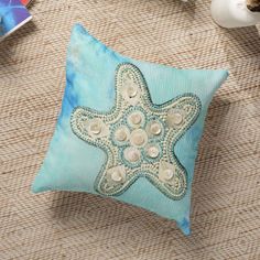 a decorative starfish pillow sitting on top of a table