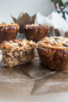 several muffins sitting on top of a table next to some paper napkins