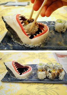 someone is eating sushi with chopsticks in the shape of a shark's mouth